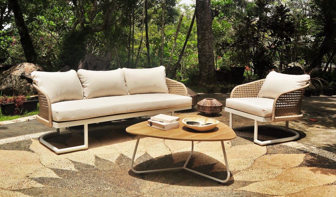 sofá y sillón de exterior en fibra artificial con mesa de centro de madera y lámpara UFO de jardín