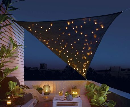 Terraza en un ático de La Zagaleta con lámparas de aluminio y toldos para jardín